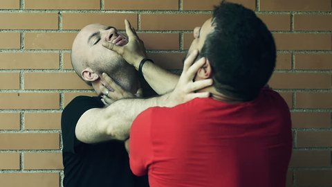 two men fights putting their hands over faces and neck. Slowmotion