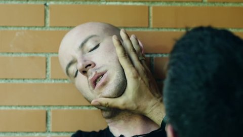 two men fights putting their hands over faces and neck. Slowmotion