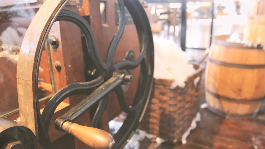 Antique pulley wheel moves on machine in old textile factory 