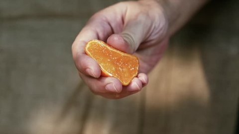 Hand Squeezing Tangerine, Slow Motion