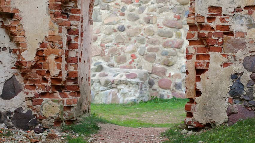Hiker with tablet PC near ancient wall
