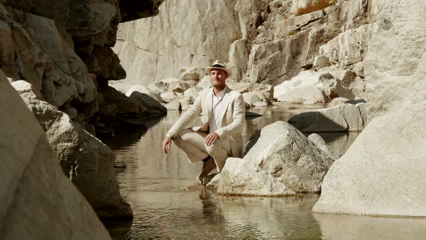 young caucasian man relaxing at mountain lake