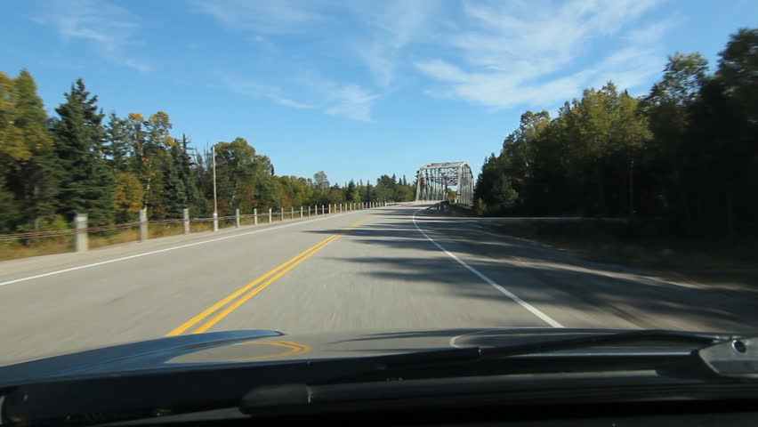 POV driving across a truss bridge. Driving across a truss bridge that crosses the Agawa River. Trans Canada HWY No 1 or Hwy ON-17 in Northern Ontario, Canada.