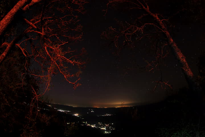 6K. Time lapse of the night sky with clouds and stars passing by behind mountain. Sokolinoye, Grand Canyon of Crimea, Crimea, Russia. Ultra HD, 5616x3744
