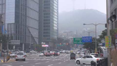SEOUL - SOUTH KOREA, APRIL 20, 2012, Busy traffic street in downtown in foggy day, view of  YTN Namsan Tower 