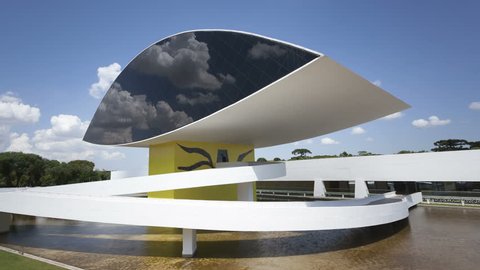 CURITIBA, BRAZIL Feb 4, 2014: 4K Time lapse of the Oscar Niemeyer Museum in Curitiba, Parana, Brazil with its eye-shaped monument and the reflection of passing clouds in the window front.