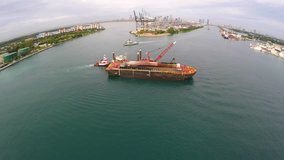 Aerial video of a barge and dredging activity in Miami 4k