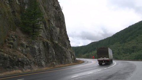 Semi truck driving up mountain road in Oregon.