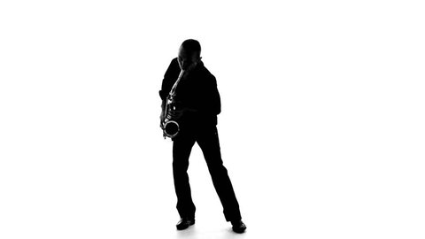 Dark silhouette of a man playing the saxophone on a white background