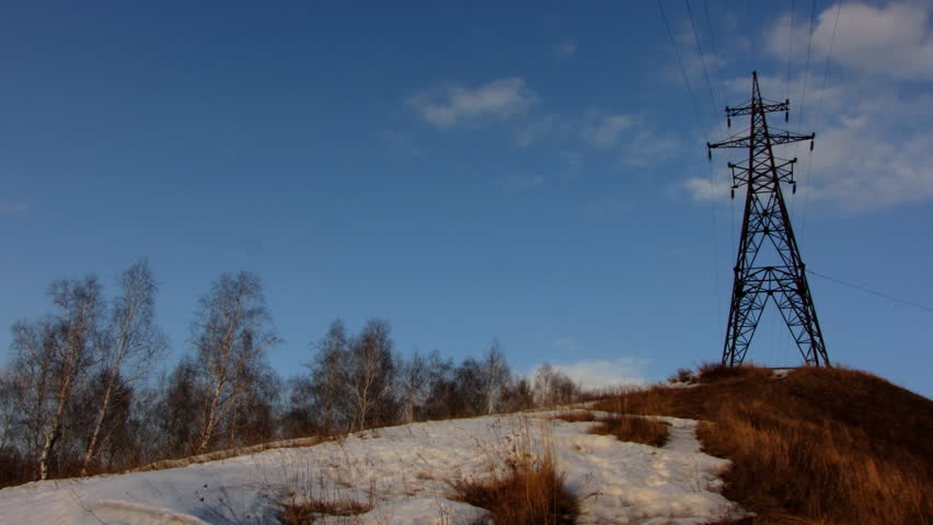 Time lapse of running clouds with electricity pylon.