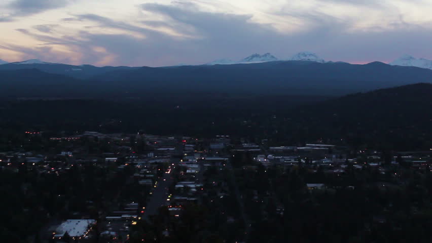 Traffic on distant highway below the Cascade Mountains from Pilot Butte Bend,Oregon at twilight-no audio