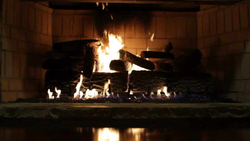 a fireplace glowing warmly in the winter (further view with reflections)