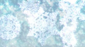 Big Christmas snowflakes loop with sparkly defocused snow or glitter background. Silver / white version. In 4K Ultra HD, HD 1080p and smaller sizes.