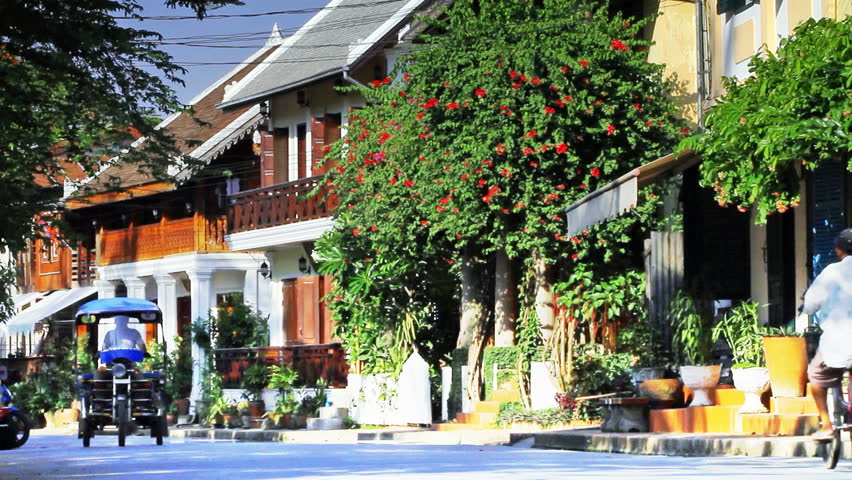 Traffic in Luang Phabang Lao  with french colonial  architecture  background