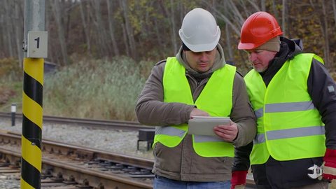 Railway engineer talking with worker