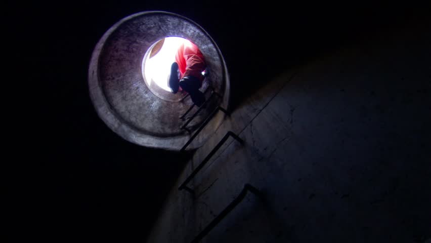 Workers climbing into a sewer tunnel. | Shutterstock HD Video #7745776