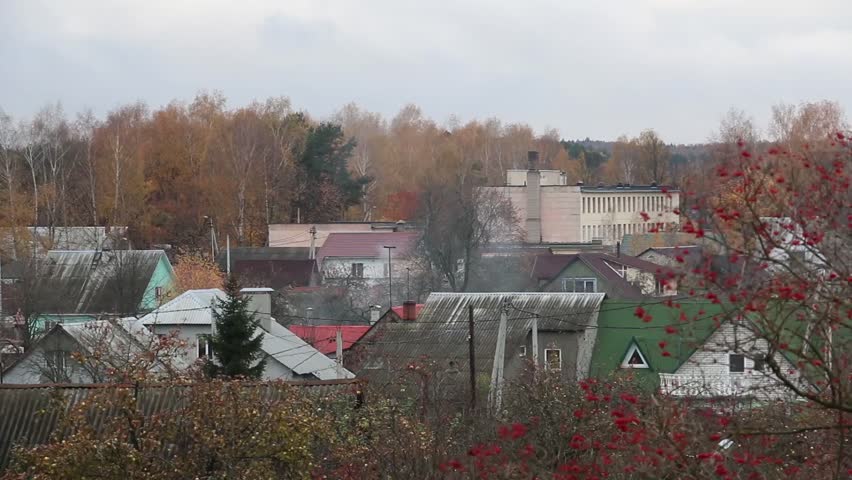 Autumn landscape, roofs of buildings, to burn the stove, the smoke comes from the chimney.