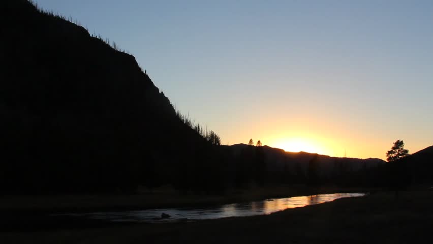 The Madison River winds its way through Yellowstone National Park, Wyoming, at sunset.