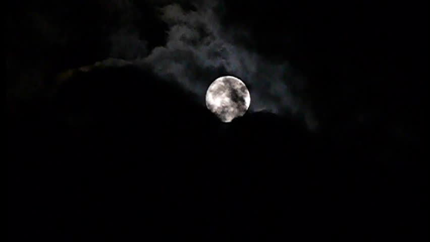 Black clouds on background full moon on night sky, a Nature Video by angellos