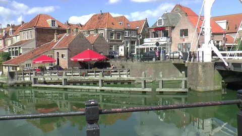 Enkhuizen,The Netherlands,-september 2014 province of North Holland :An old draw bridge opens for a sailing yacht in the historic harbour of Enkhuizen