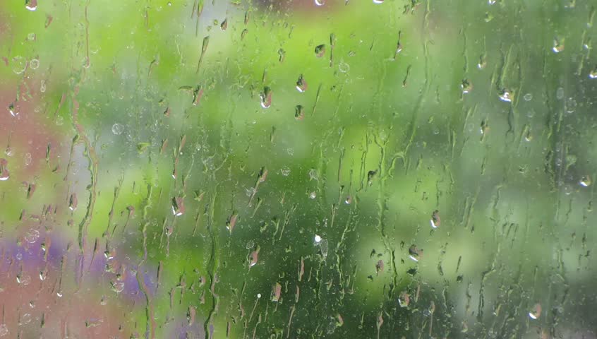 Raindrops running down a windowpane