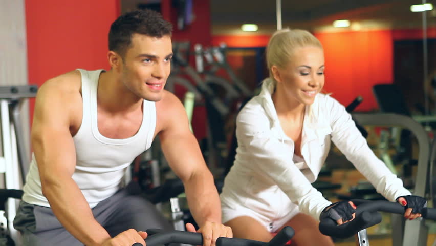 Sporty couple are exercising at gym centre