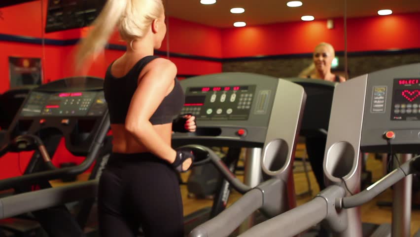 Beautiful sporty woman is exercising at the gym centre