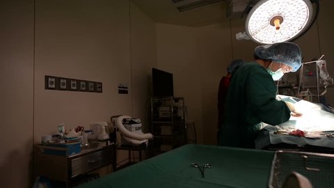 dolly shot of veterinarian doctor in operation room for surgical