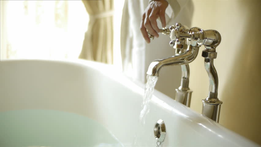 Woman In Bathrobe Turning On Stock, Bathtub Water Faucet