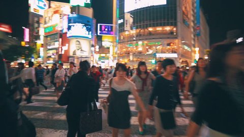 TOKYO - JAPAN, MAY 25, 2014: People crossing the street outside the famously crowded Shibuya station from point of view (POV) perspective, Tokyo, Japan.