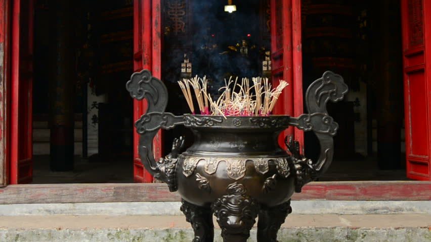 Incense Sticks Burning in Giant Pot in Front of Buddhist Temple 