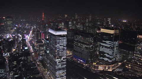 Aerial Metropolis night illuminated entertainment area offices skyscrapers Tokyo Tower city blocks structure Business District Japan स्टॉक व्हिडिओ