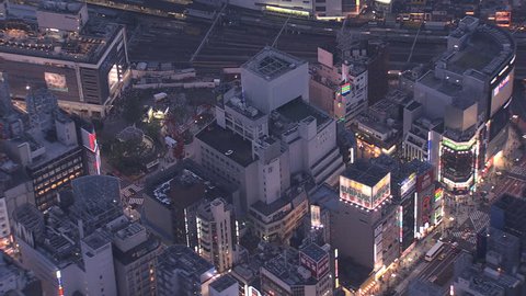 Aerial illuminated dusk view Shinjuku buildings downtown people nightlife Skyscrapers neon city lights National Rail Japan