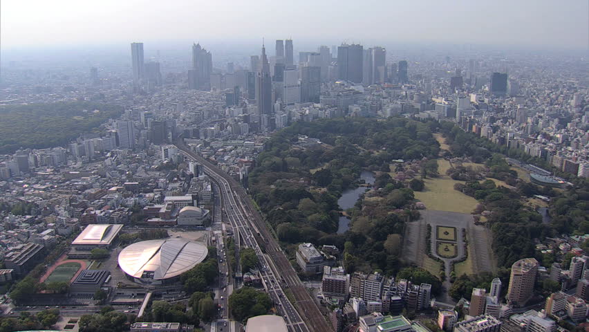 Aerial view Shinjuku Gyoen National Garden Landscape Park cherry blossom city skyline vehicle Expressway Tokyo