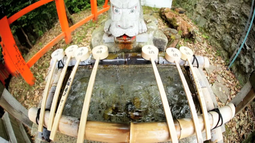 Fushimi Inari Taisha Japanese sacred hand washing shrine entrance to Torii gates Buddhist temple travel Kyoto Japan Asia