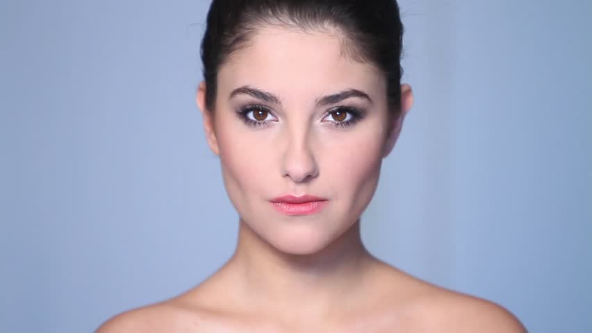 Beautiful young woman doing makeup 