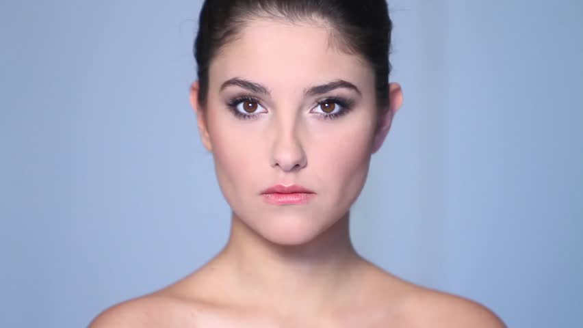 Beautiful young woman doing makeup 