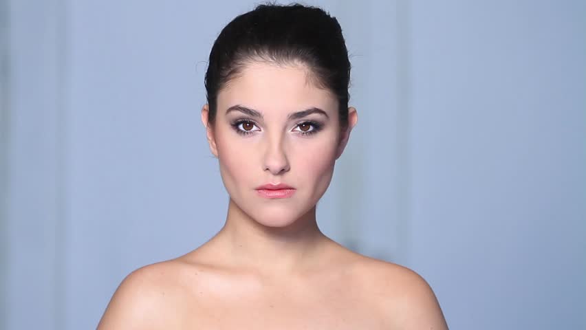 Beautiful young woman doing makeup 