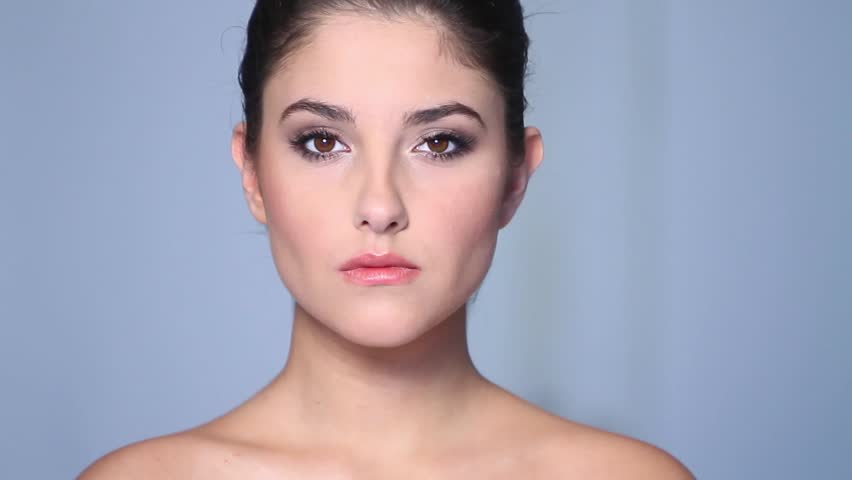 Beautiful young woman doing makeup 