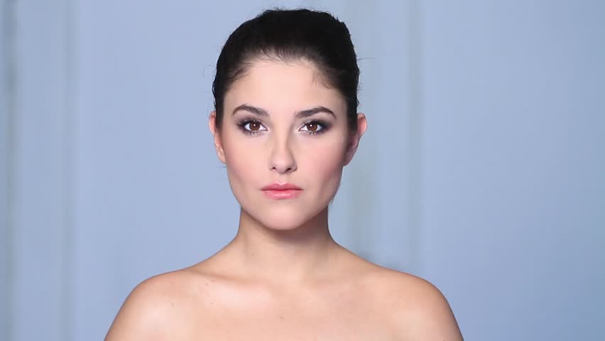 Beautiful young woman doing makeup 