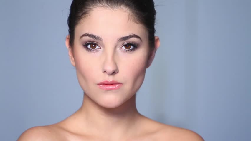 Beautiful young woman doing makeup 