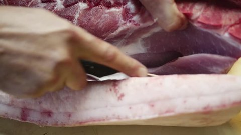 Old butcher preparing pork meat in slow motion