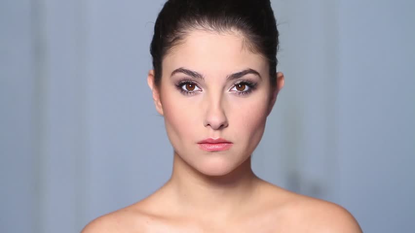 Beautiful young woman doing makeup 