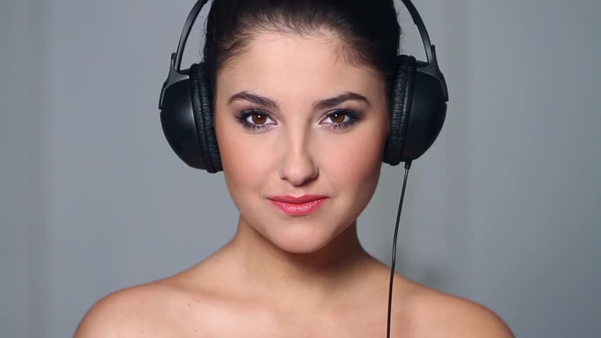 Beautiful young woman listen to music in headphones 