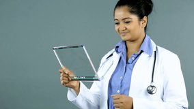 Video montage Indian female doctor using wireless touch screen navigation technology medical data motion graphics