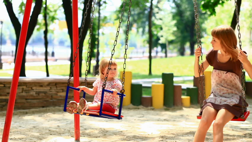 The child and his mother ride on a swing in the park -2.