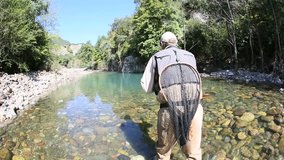 Back view of fly fisherman in river 