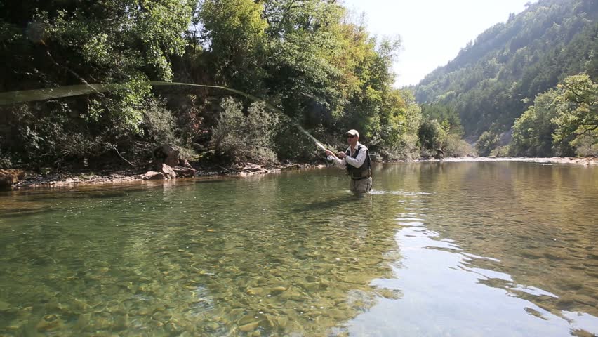 Front view of fly fisherman in river 