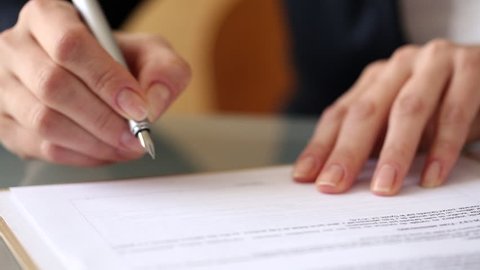 Woman signing a contract with a Fountain Pen