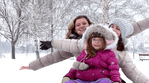 Happy family has fun in the wintry park.Slow motion, high speed camera